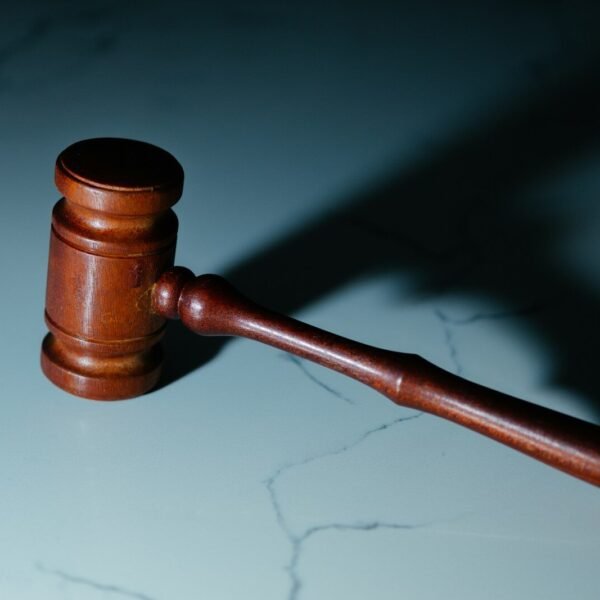 a wooden judge's hammer sitting on top of a table