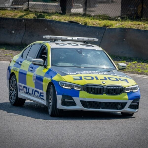 a police car driving down a race track